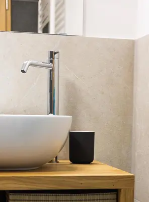 a bathroom sink sitting on a wooden table at Garden 13 in Tolmin