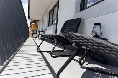a pair of chairs sitting on a balcony at ININ APARTMENTS in Bled