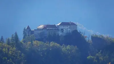 a castle on the side of a mountain at ININ APARTMENTS in Bled