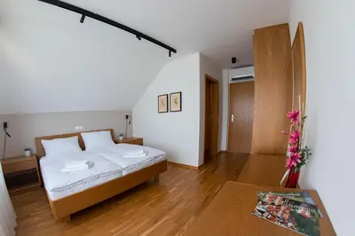 a bedroom with a bed and a table at Hiša na Vrtu in Šenčur
