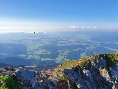 a kite is flying over a mountain at Hiša na Vrtu in Šenčur