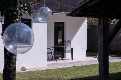 a house with two spheres hanging from a tree at Garden Apartments Bled in Bled