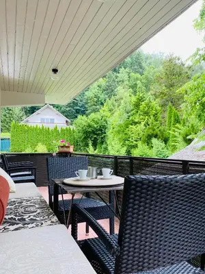 a patio with a table and chairs on a porch at Garden Apartments Bled in Bled