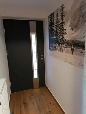 a room with a black door and a picture on the wall at Žbogar in Rateče