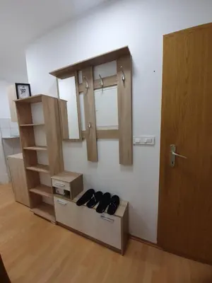a pair of shoes in a room with a door at RAILWAY STATION CITY MODERN APARTMENT in Maribor