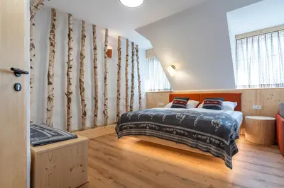 a bedroom with a bed in a room at Guesthouse & Camping Danica Bohinj in Bohinj