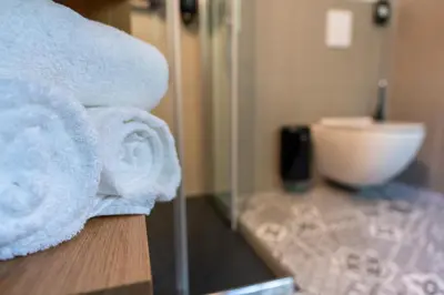 a pile of towels on a counter in a bathroom at Guesthouse & Camping Danica Bohinj in Bohinj