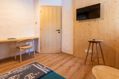a room with a door and a table and a desk at Guesthouse & Camping Danica Bohinj in Bohinj
