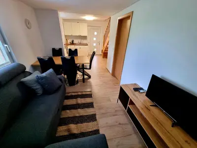 a living room with a couch and a table at Apartment Organic Farm Hvadnik in Tržič