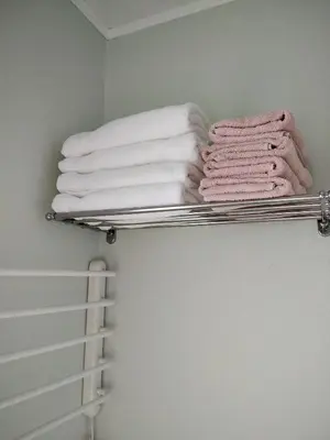 a towel rack with towels on it in a bathroom at ECO-LUX APART with free bicycles end free parking in Ljubljana