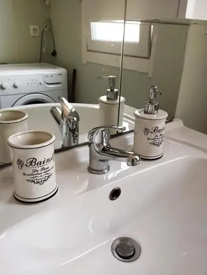 a bathroom sink with two coffee cups on it at ECO-LUX APART with free bicycles end free parking in Ljubljana