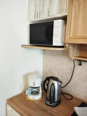 a kitchen counter with a coffee maker and a toaster at ECO-LUX APART with free bicycles end free parking in Ljubljana