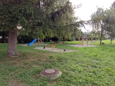 a park with a playground with a tree and a slide at ECO-LUX APART with free bicycles end free parking in Ljubljana