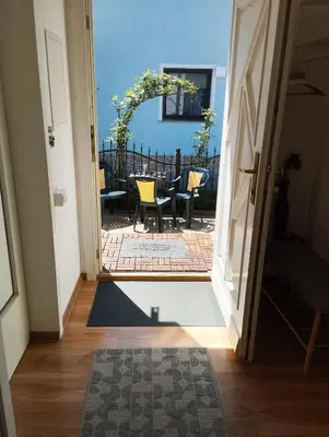 an open door to a patio with a table and chairs at ECO-LUX APART with free bicycles end free parking in Ljubljana
