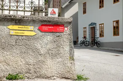 a stone wall with signs on it next to a building at Apartmaji-Utrinek 