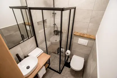a small bathroom with a sink and a toilet at Apartmaji-Utrinek 