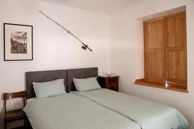 a bedroom with a bed and a wooden cabinet at Apartmaji-Utrinek 
