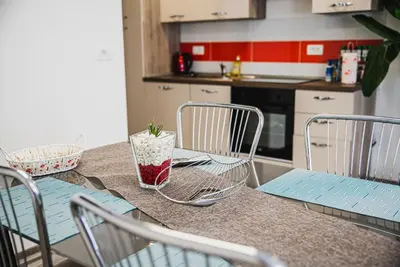 a kitchen with a counter with chairs and a table at CUDERLAND - Petra in Kobarid