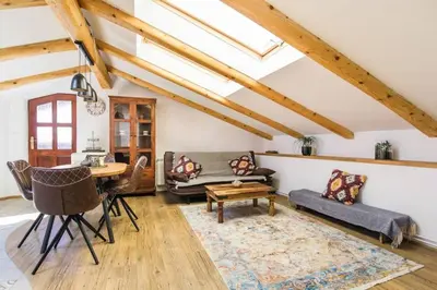 a living room with a couch and a table at Apartma Luna with mountain view in Kobarid