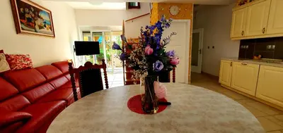 a vase of flowers sitting on a table in a living room at Apartment Luna in Ptuj