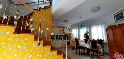 a living room with a staircase and a dining room at Apartment Luna in Ptuj