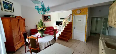 a living room with a table and a chandelier at Apartment Luna in Ptuj