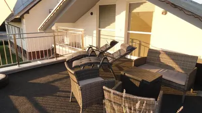 a patio with chairs and a grill on a balcony at Mali Portorož v Prlekiji in Ljutomer