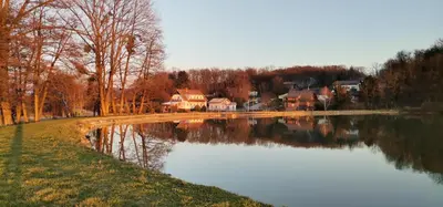a lake with houses in the background next to a town at Mali Portorož v Prlekiji in Ljutomer