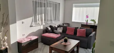 a living room with a couch and a table at Mali Portorož v Prlekiji in Ljutomer