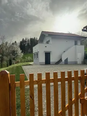 a white house behind a wooden fence at Grajsko in Metlika