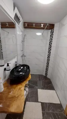a bathroom with a black sink and a shower at Grajsko in Metlika