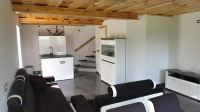 a living room with a couch and a kitchen at Grajsko in Metlika