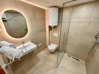 a bathroom with a shower and a sink and a toilet at Glamping Tent Water Village Rogla in Oplotnica