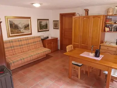 a living room with a couch and a table at Glamping Tent Water Village Rogla in Oplotnica
