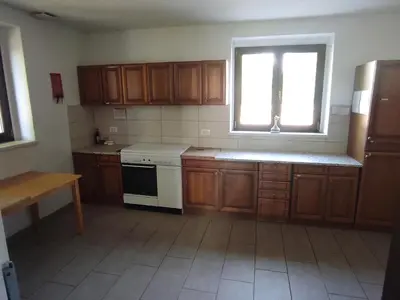 a kitchen with wooden cabinets and a sink and a window at Park Istra holiday home in Koper