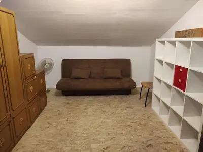 a living room with a brown couch and a shelf at Park Istra holiday home in Koper