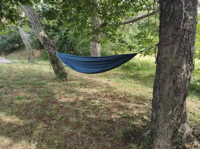 a blue hammock hanging between two trees in a field at Park Istra holiday home in Koper