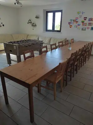 a large wooden table and chairs in a room at Park Istra holiday home in Koper