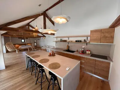 a kitchen with a table and chairs in a room at Škerlj Wine Estate in Tomaj