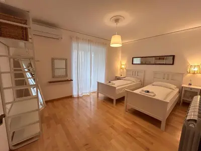 a living room with two beds and a ladder at Škerlj Wine Estate in Tomaj