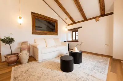 a living room with a white couch and a table at Škerlj Wine Estate in Tomaj
