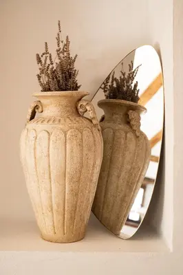 two vases sitting on a shelf in front of a mirror at Škerlj Wine Estate in Tomaj