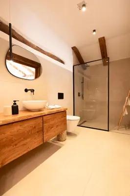 a bathroom with a sink and a glass shower at Škerlj Wine Estate in Tomaj