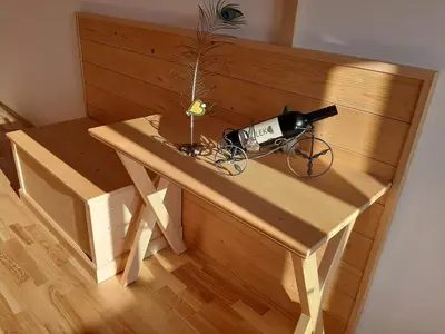 a wooden table with a bottle of wine on it at Rooms & Wine Lilek in Šentilj