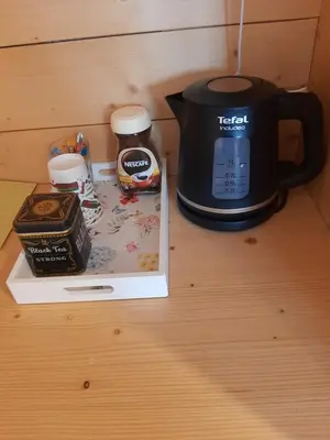 a table with a coffee maker and a tea kettle and a box at Rooms & Wine Lilek in Šentilj
