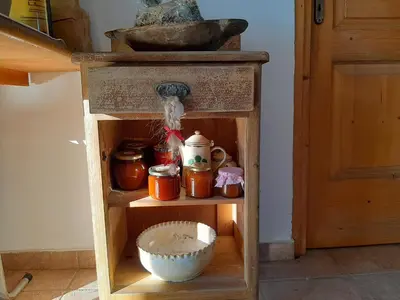 a shelf with jars and a bowl in a room at Rooms & Wine Lilek in Šentilj