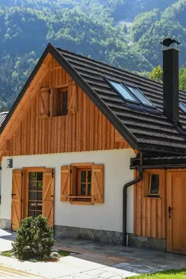 a house with a gambrel roof with windows at JULIAN VILLAGE LEPENA in Soča
