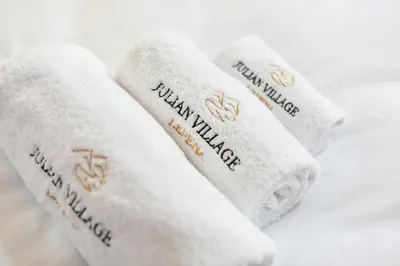 two white towels with the words milwaukee village on them at JULIAN VILLAGE LEPENA in Soča