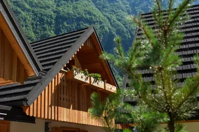 a building with a balcony with plants on it at JULIAN VILLAGE LEPENA in Soča