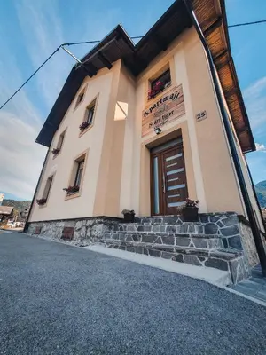 a small building with stairs in front of it at Apartments STARI TIGER in Bohinj